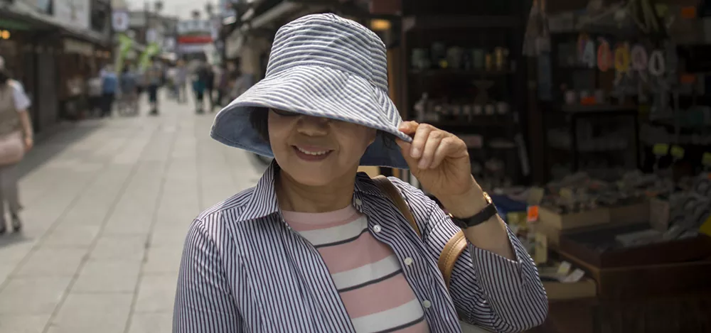 Yuko Yoshikawa has a eye disease and shelters her eyes from the sun in Tokyo.