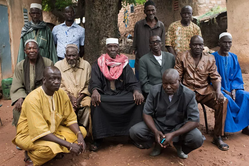 Adama Kone, the village chief in Bougoula, Mali, sits with his council of elders.