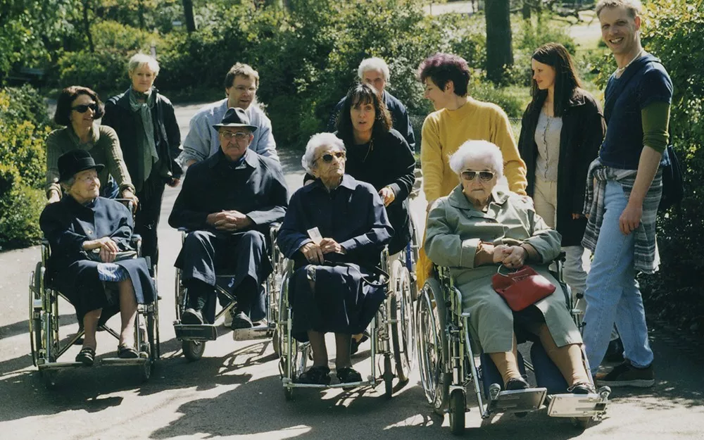 Novartis volunteers pushing elderly citizens in wheelchairs around in Basel