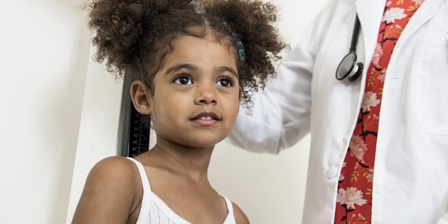 Girl being weighed in a doctor's office