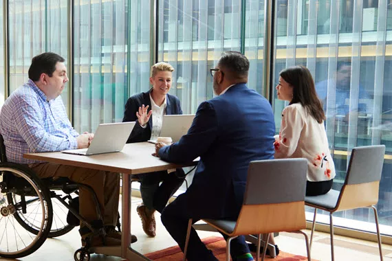A group of four Novartis associates in a team meeting
