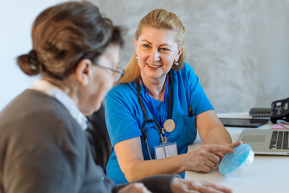 Doctor with senior woman in an office