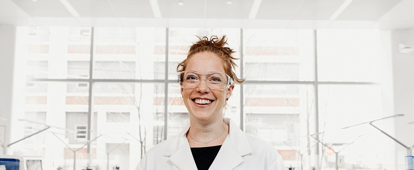 Smiling scientist in a lab wearing security glasses