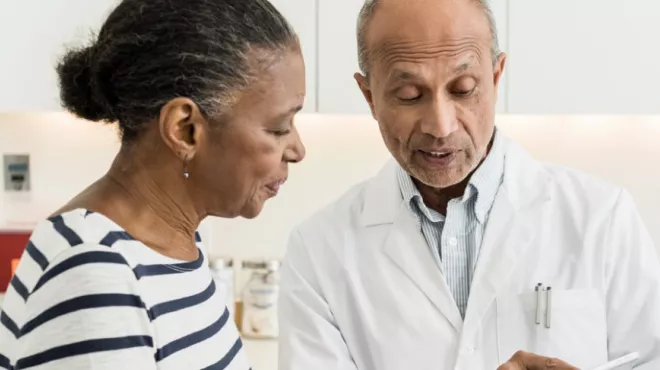 A doctor discusses different clinical trial options with a patient.