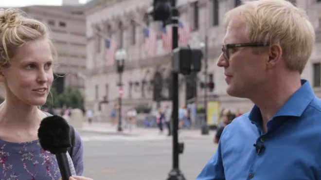 Novartis scientist talks to woman on the street.