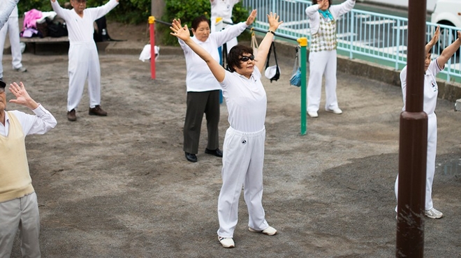 A group of several people exercise outdoors in Tokyo. Yuko Yoshikawa and others partake in a communal fitness session outdoors in Tokyo.