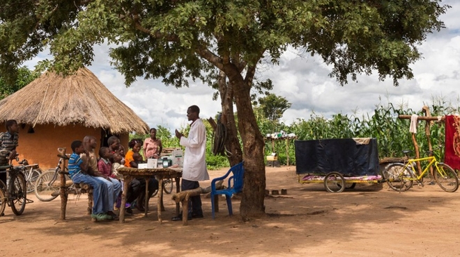 Healthcare worker, Dismus Mwalukwanda, discussing with a group of people in a rural part of Zambia Healthcare worker, Dismus Mwalukwanda, discussing with a group of people in a rural part of Zambia