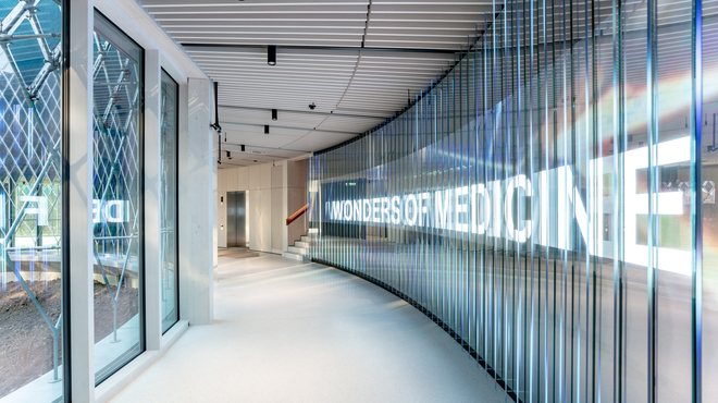 Welcome wall and staircase to the exhibition Wonders of Medicine in the Novartis Pavillon