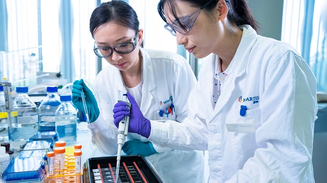Two scientists performing chemical analysis