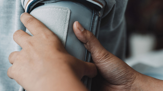 Healthcare professional uses blood pressure cuff on patient