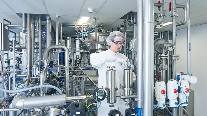 Production specialist closing a valve in Schaftenau, Austria