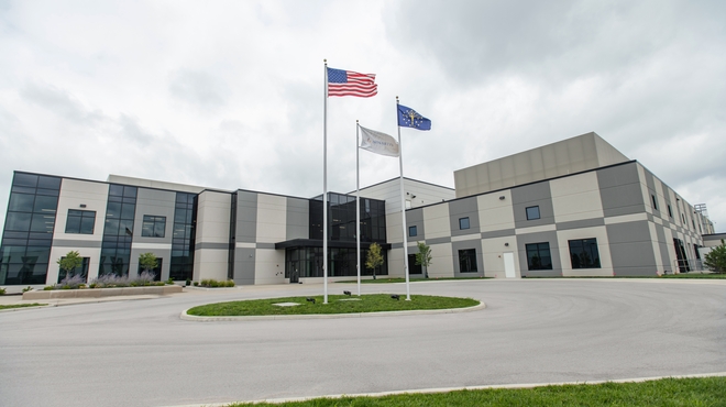 Three flags fly outside a Novartis manufacturing facility