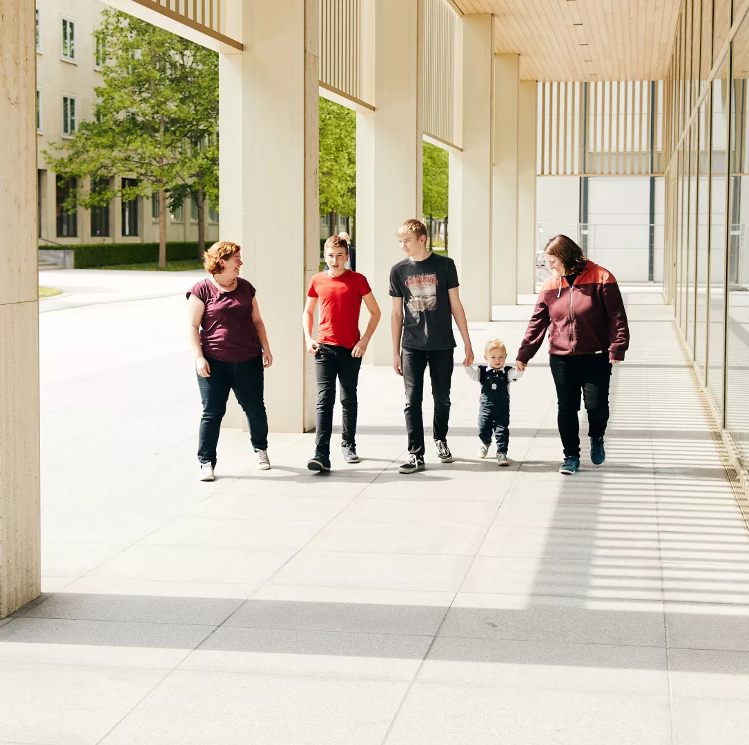 Happy family walking on Basel campus