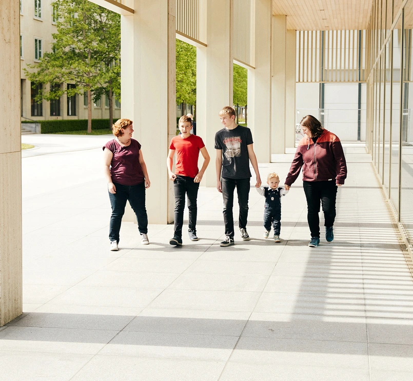 Happy family walking on Basel campus