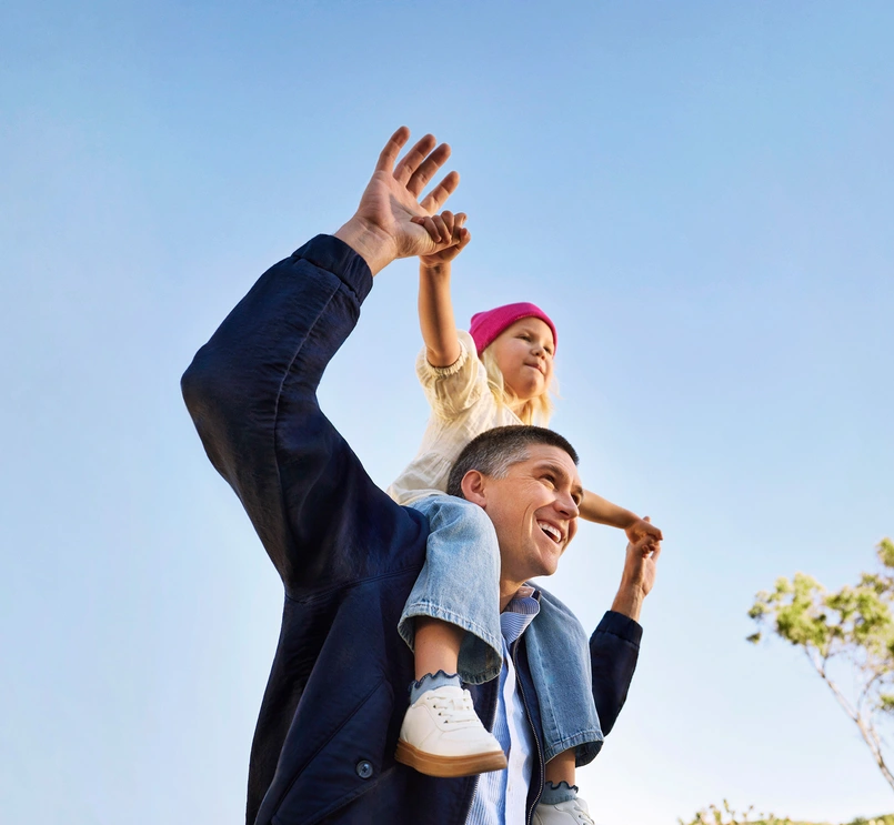 Happy father with daughter on his shoulders