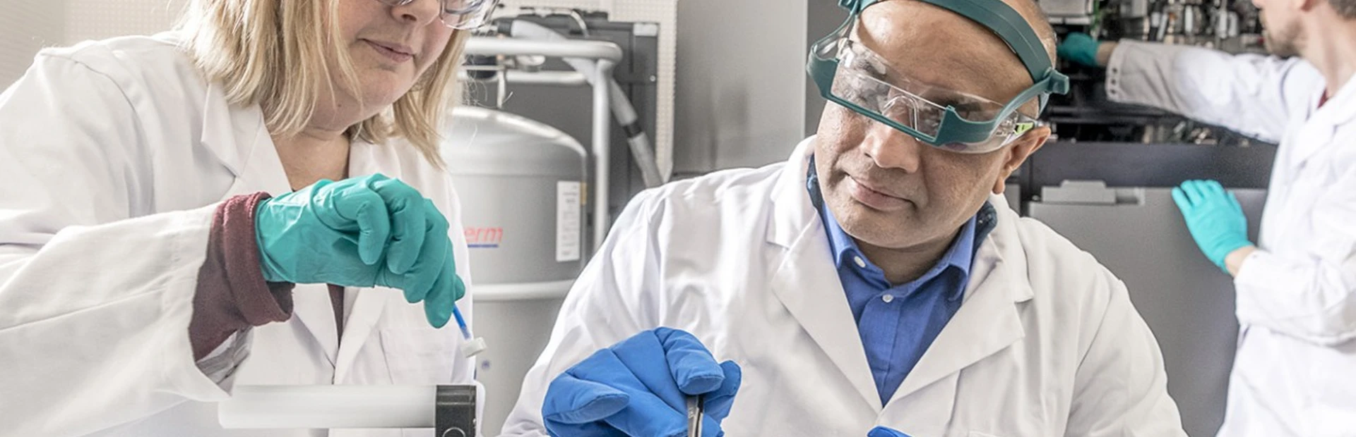 Scientists prepare a sample for imaging by a cryo-electron microscope.