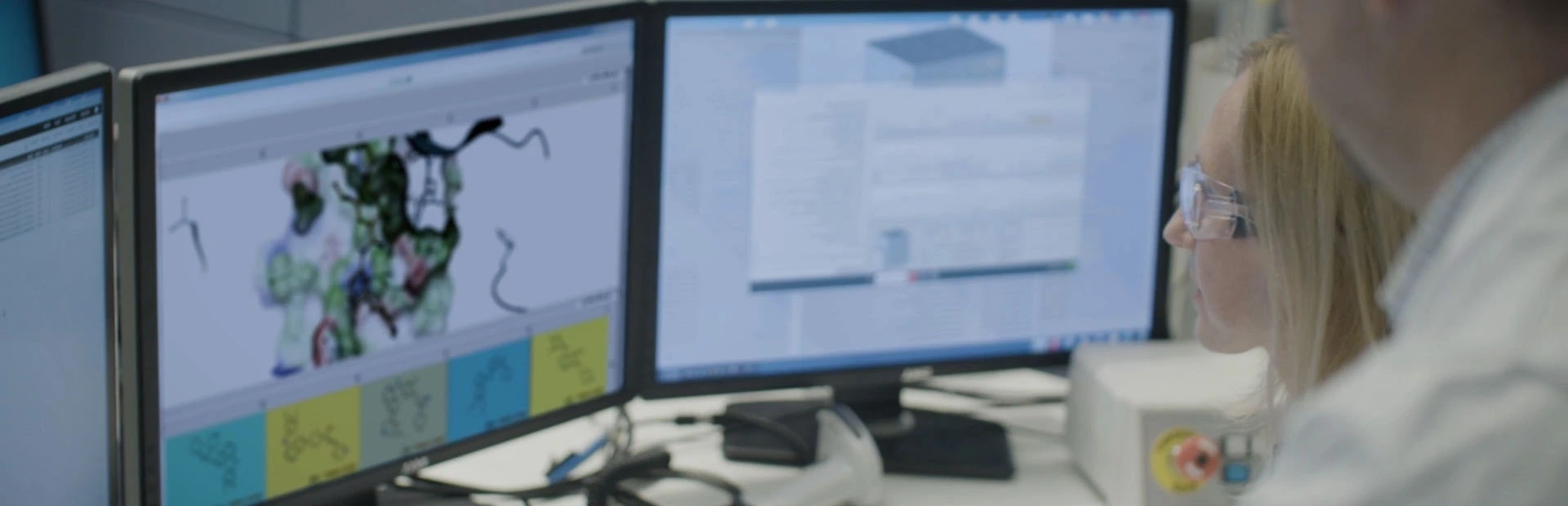 Scientists looking at data on screens