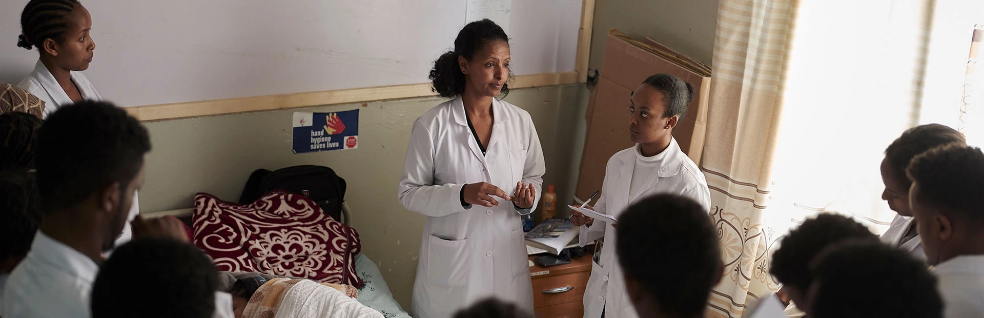 Team of doctors in a patient's hospital room