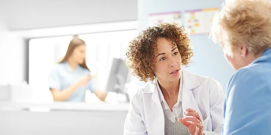 A doctor speaks with a patient