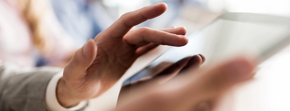 Narrow photography of a man using a tablet