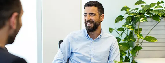 Two Novartis associates, in Dubai, having a conversation in an office