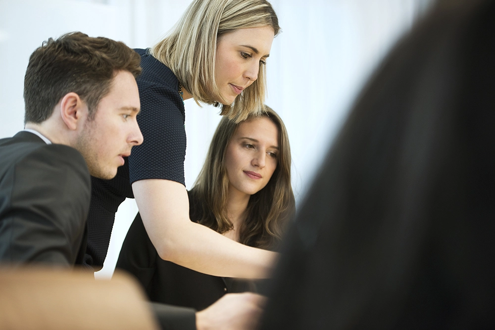 Three business people working together in a meeting
