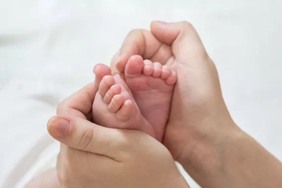 Mum holding newborn's feet