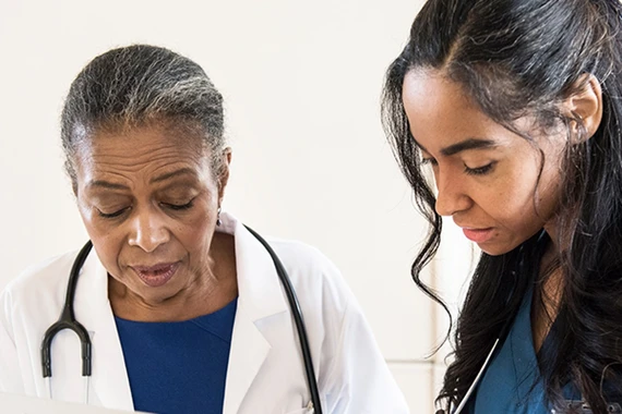 Image of two healthcare professionals interacting