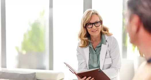 Doctor discussing illness with patient in an office