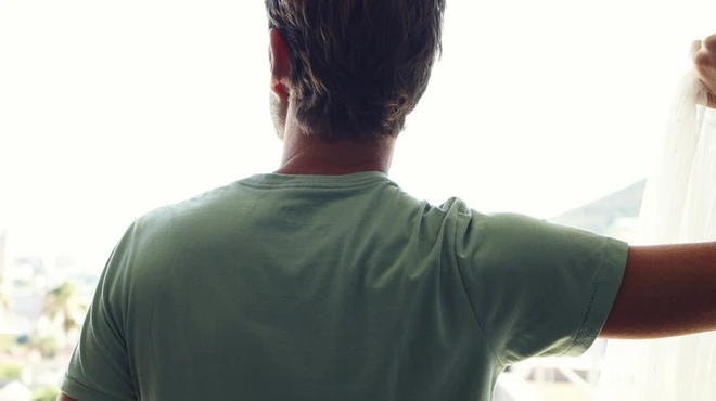 Man looking out of a window