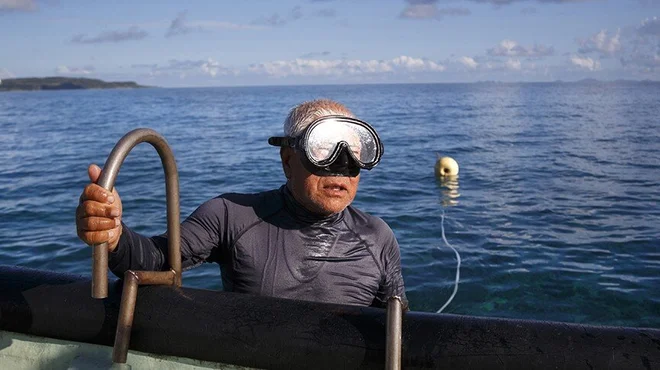 Tomi Miagi going out of the water after diving