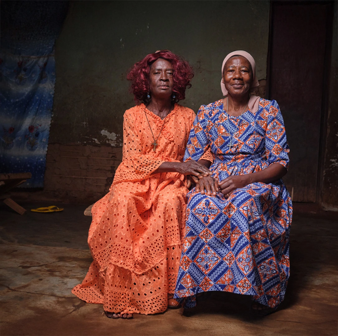 Sitting portrait of two women in colorful traditional dresses in Cameroon