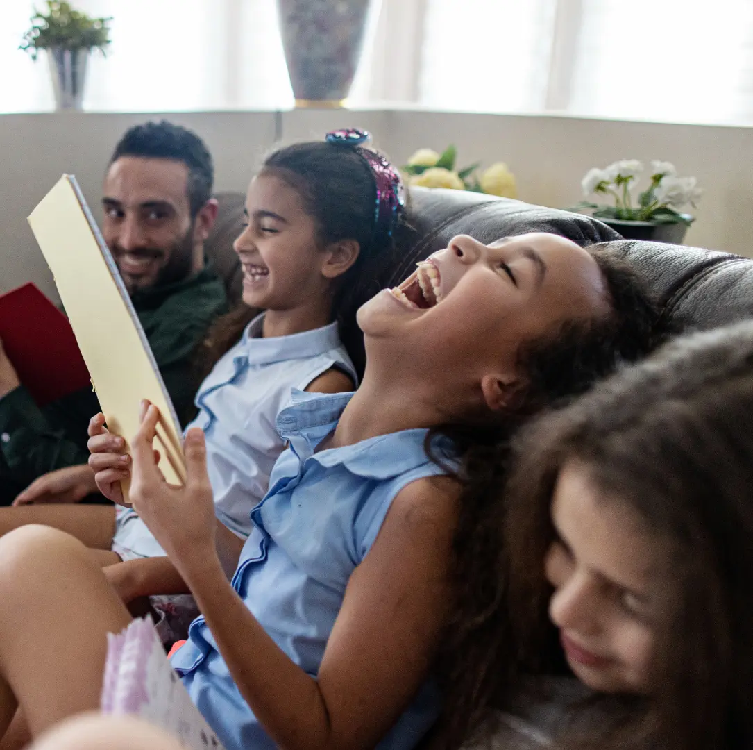 People laughing together on a sofa