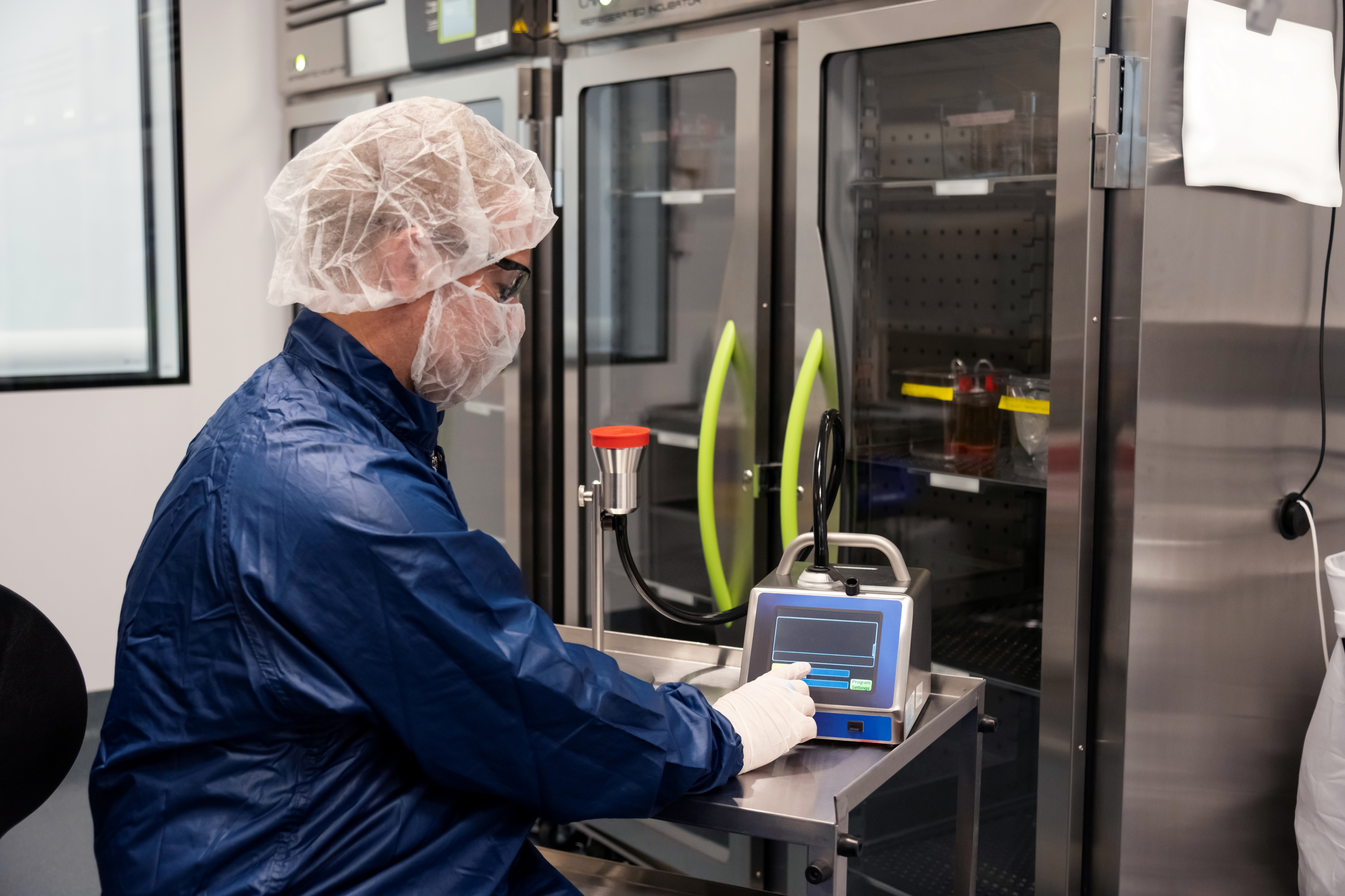 Associate in full personal protective equipment conducting quality control testing