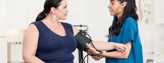 hcp-taking-patient-blood-pressure-card