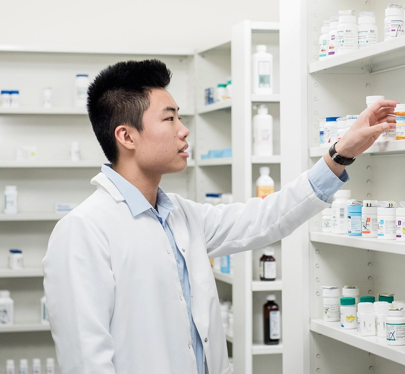 Pharmacist reaching for prescription 