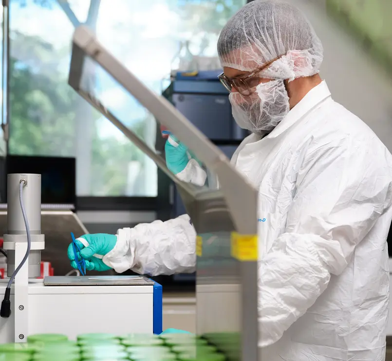 Scientist in protective gear working in a laboratory