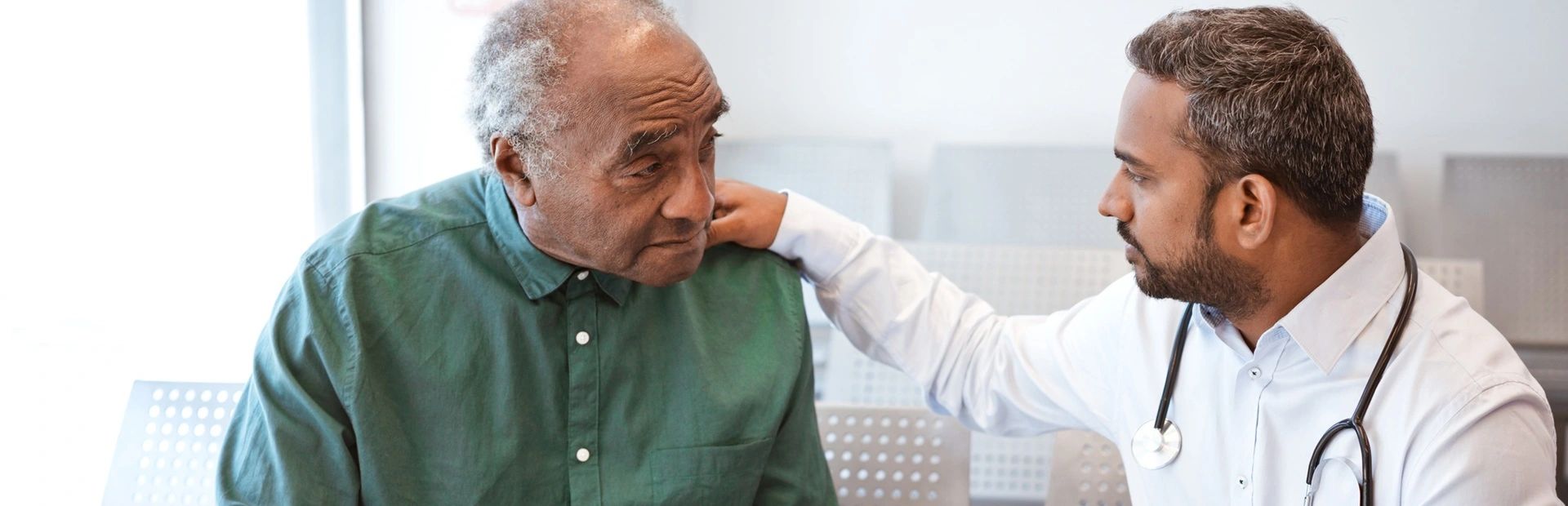 Doctor consoling male patient