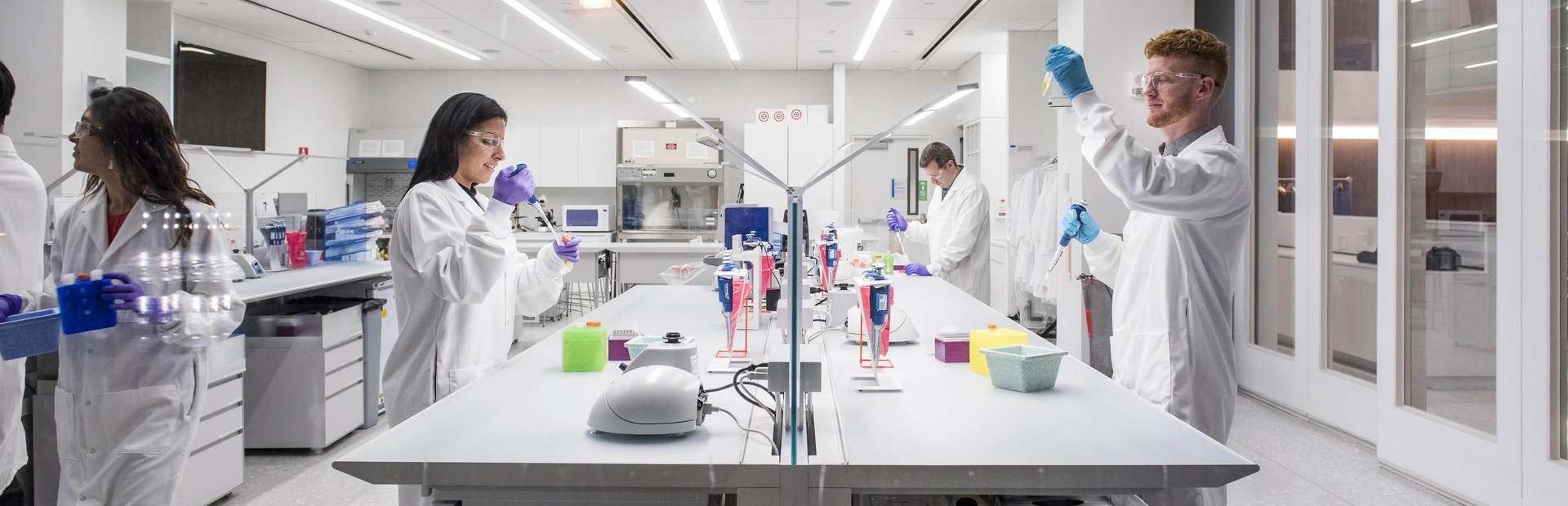 Scientists working in a lab, featured in a story about the future of treating autoimmune disease and the work that Novartis is doing to support it.