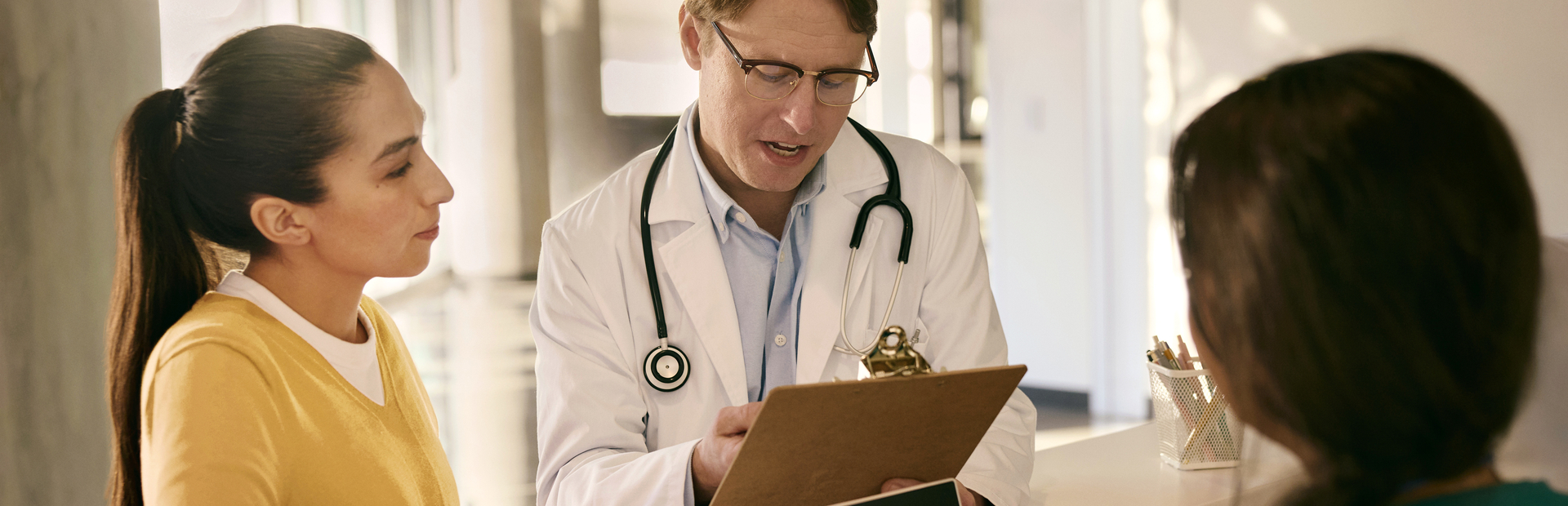 Doctor consulting with a patient at reception desk