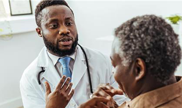A healthcare professional speaking with a patient