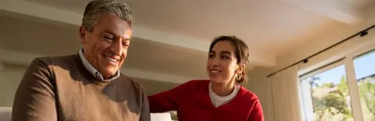 Two people smiling while engaging in a conversation