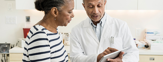 Doctor showing patient Ipad
