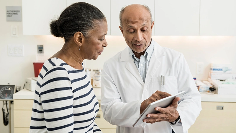Doctor showing patient Ipad
