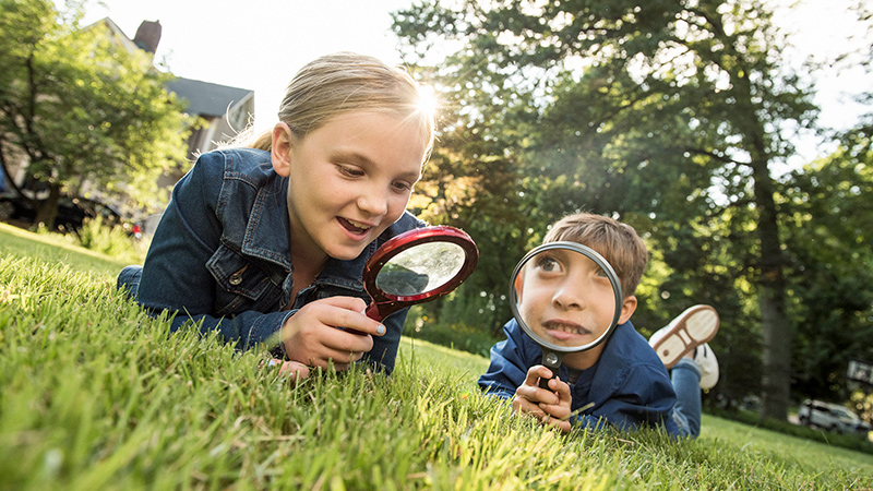 Young boy and young girl look at microscope 2
