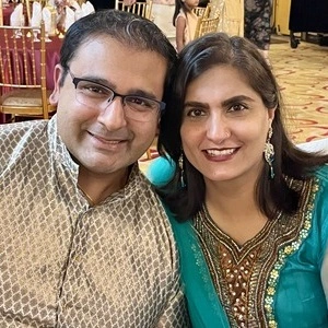 Tina and Anand smiling for a photograph