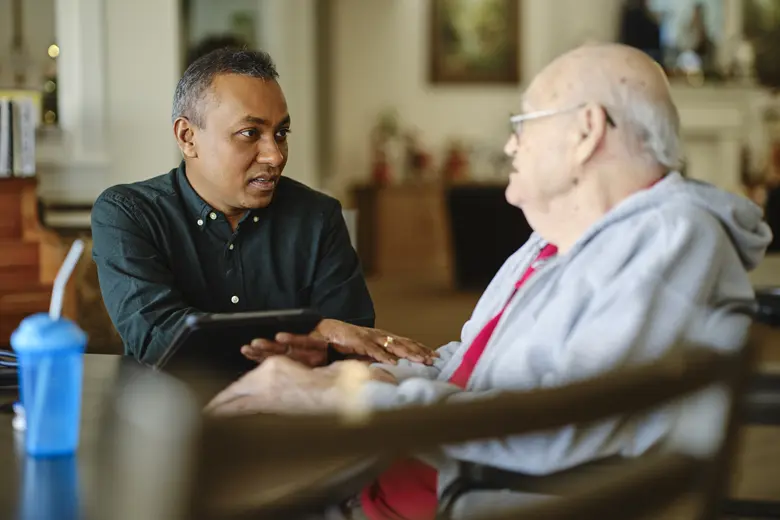 Male patient discussing treatment options with healthcare provider during oncology consultation
