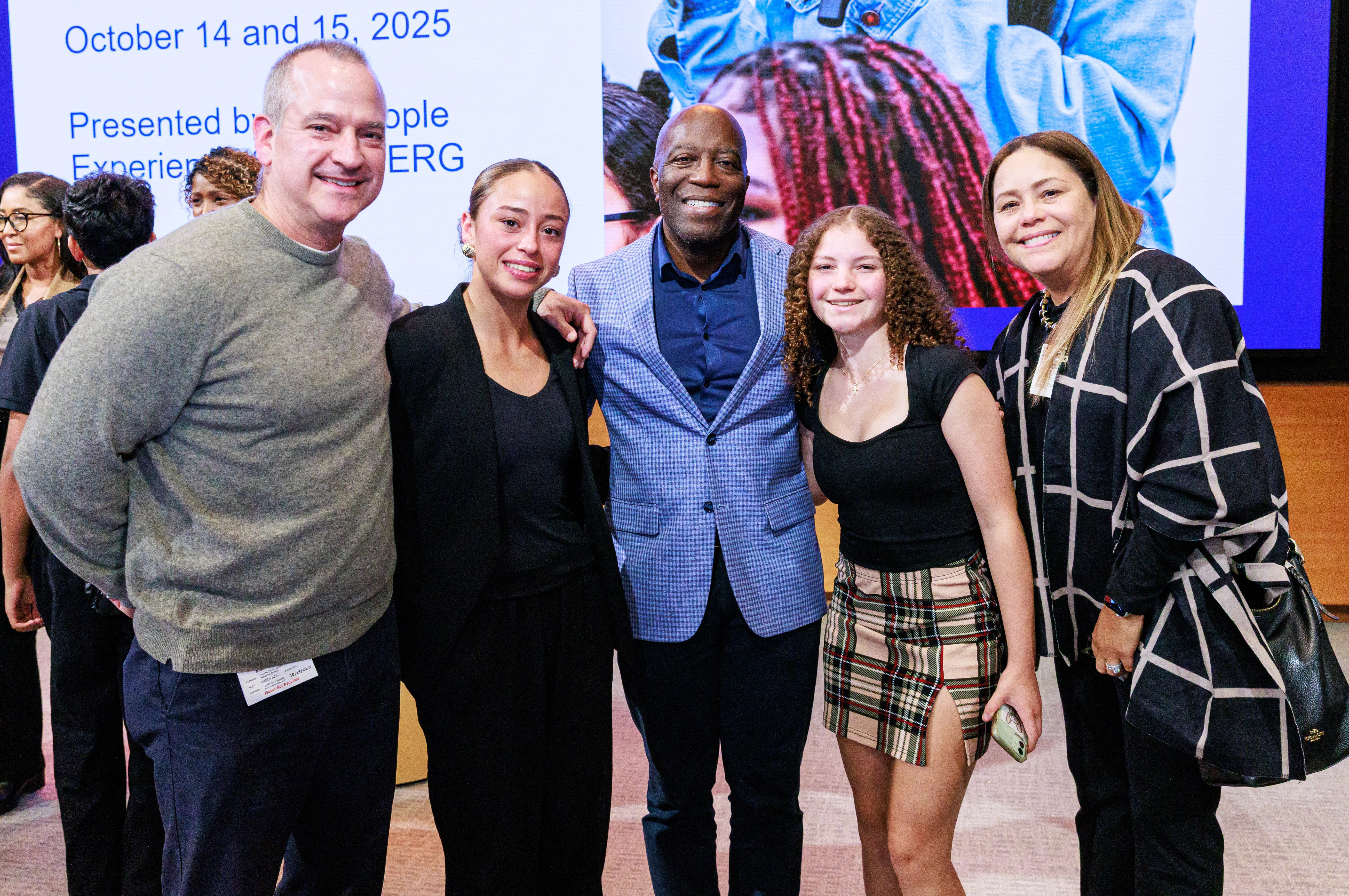 Adrian Hawkins (center): A Novartis employee who founded the Teen Corporate Mentoring Program, along with Lucia Nash, a mentee, her younger sister and parents. 