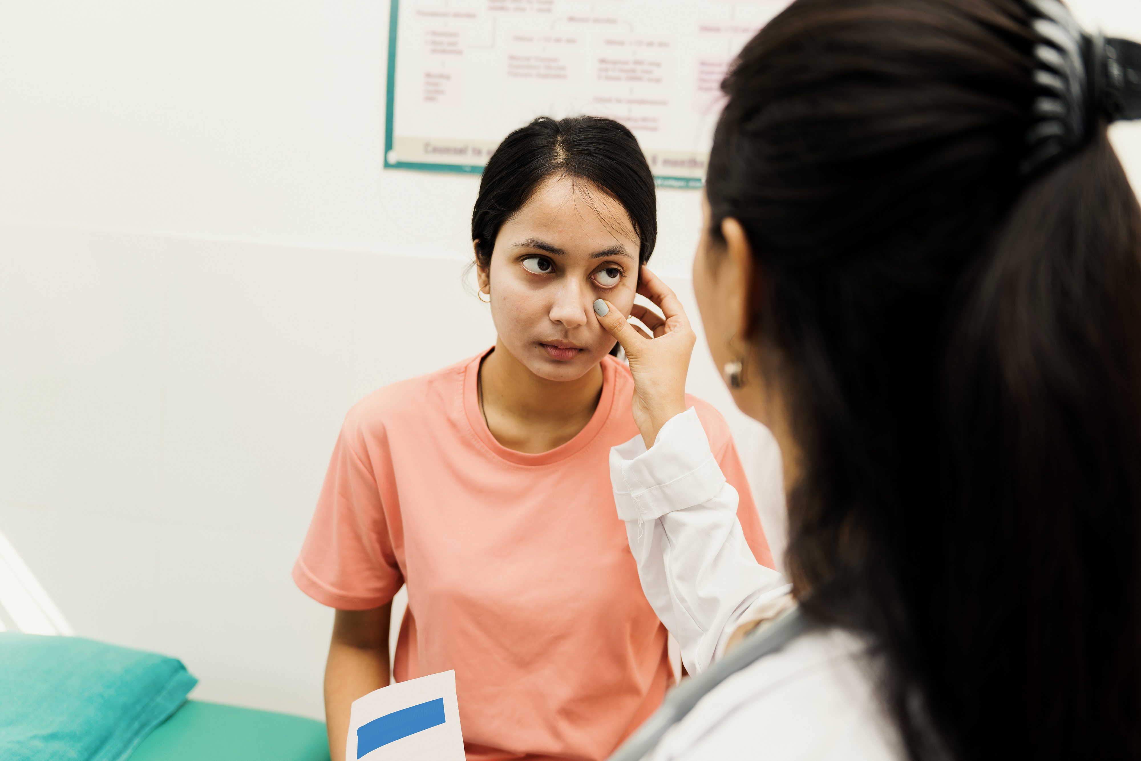 A doctor examines patients’ eyes in a story about the future of treating autoimmune diseases, such as Sjögren’s disease, where dry eyes are a common symptom.