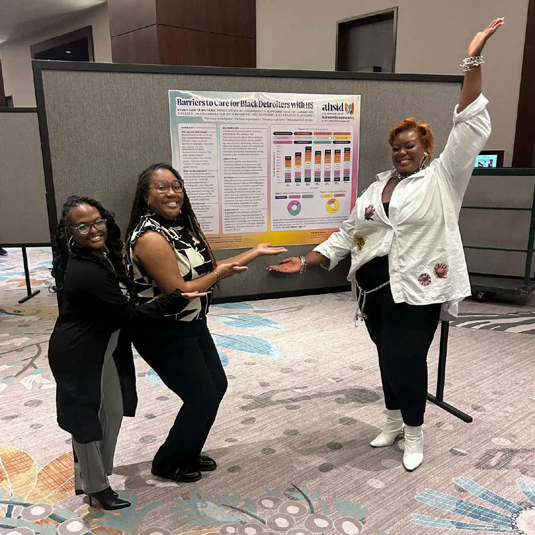 Three patient advocates posing enthusiastically in front of a research poster at a conference, gesturing toward the displayed chart and findings.